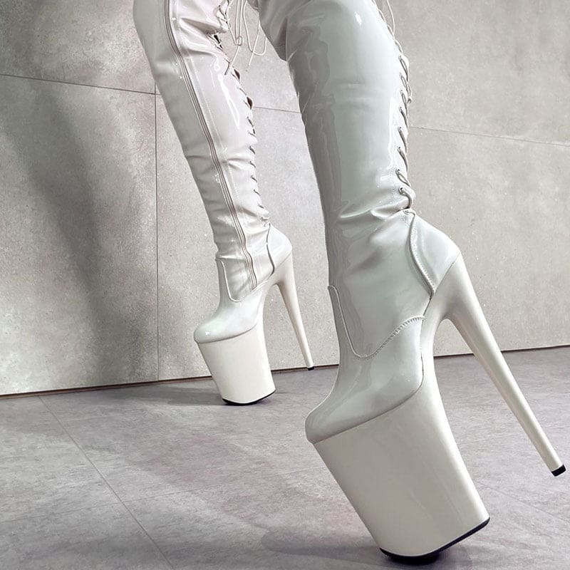 Extremely high platform stiletto boots in white leather with exaggerated soles.