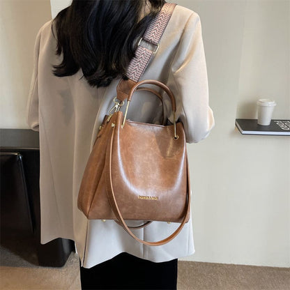 Brown leather handbag with a shoulder strap.