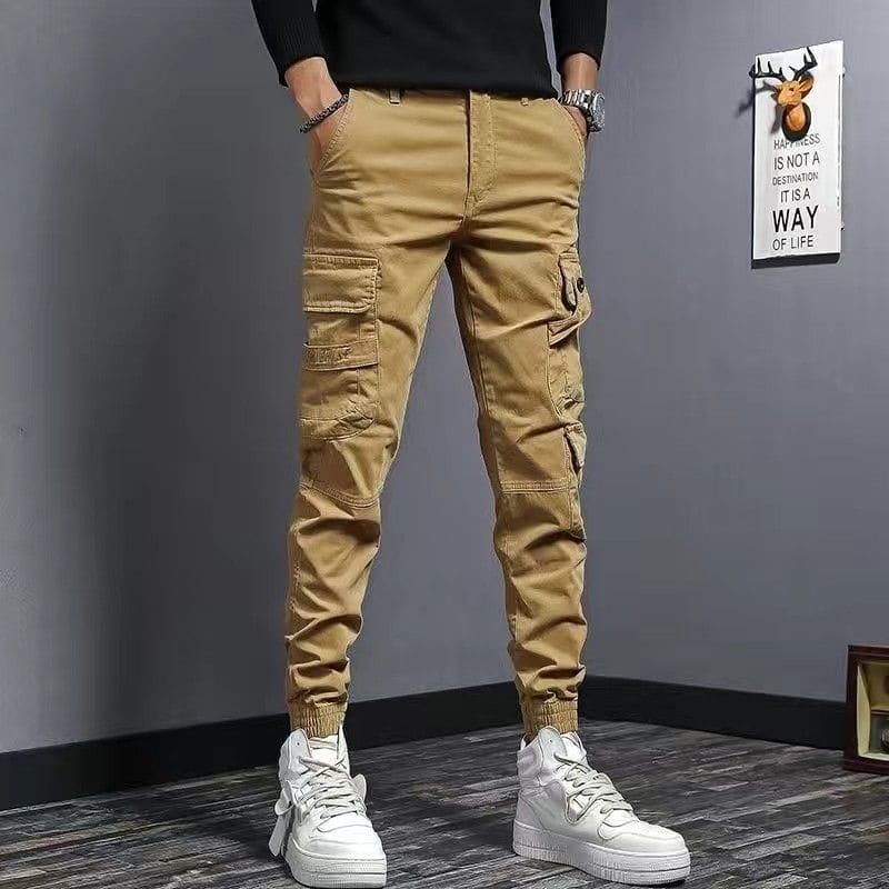 Khaki cargo pants with multiple pockets and elastic cuffs at the ankles.