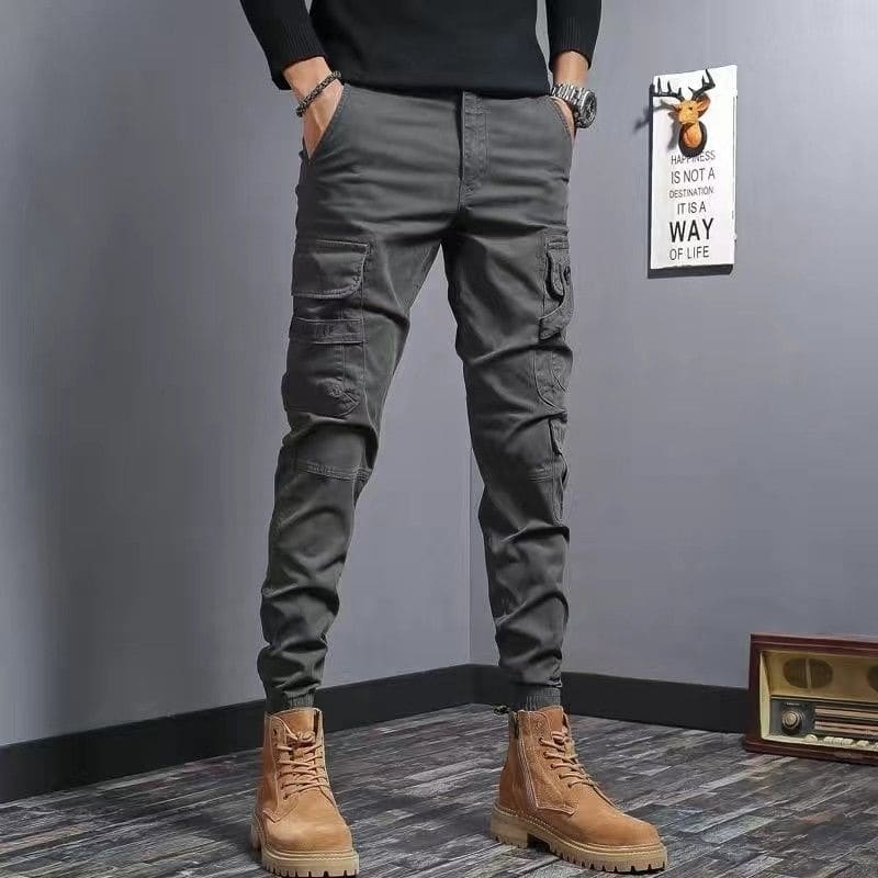 Gray cargo pants with multiple pockets and tapered legs.