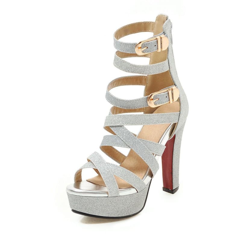 Strappy silver high-heeled platform sandal with buckle closures.