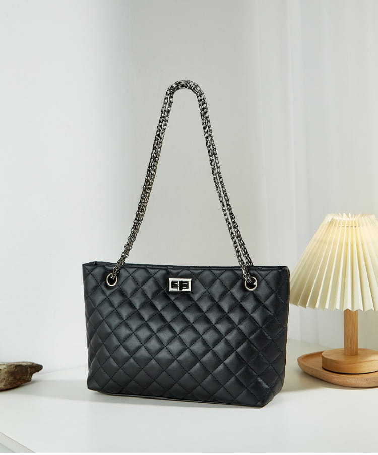 Black quilted leather handbag with shimmering chain strap and diamond plaid design.