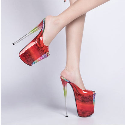 Extremely high platform stiletto heels in shiny red with a metallic spike heel.