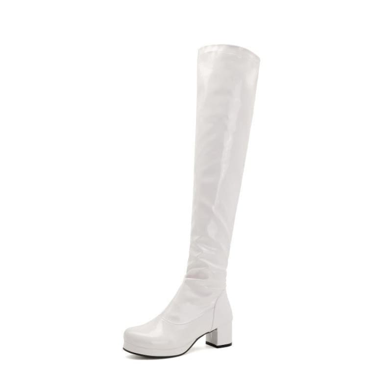 White knee-high boot with a chunky heel.