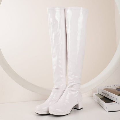 Pair of white knee-high boots with chunky heels.