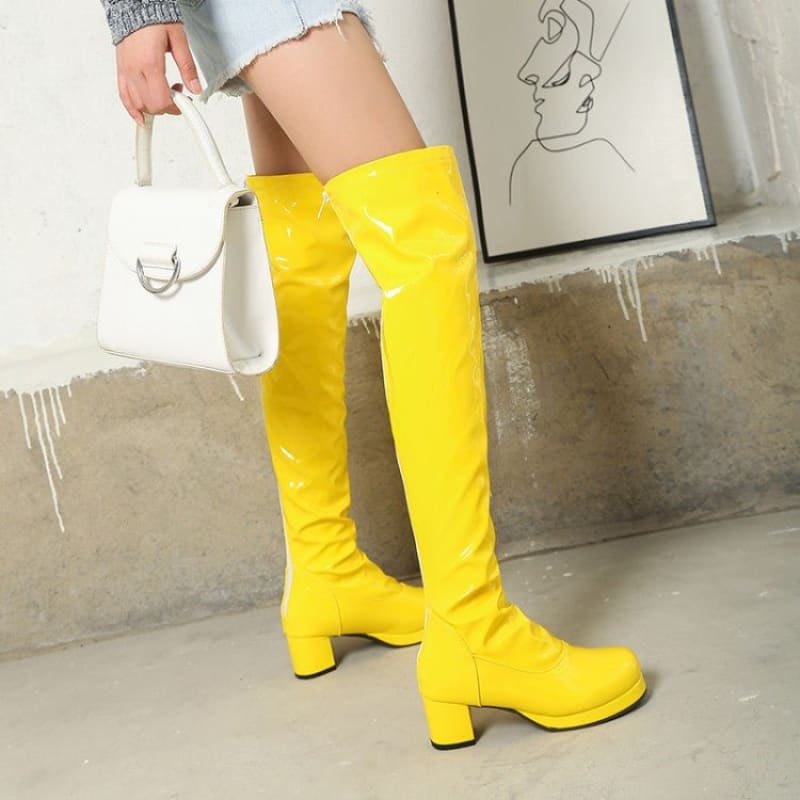 Bright yellow knee-high boots with chunky heels.