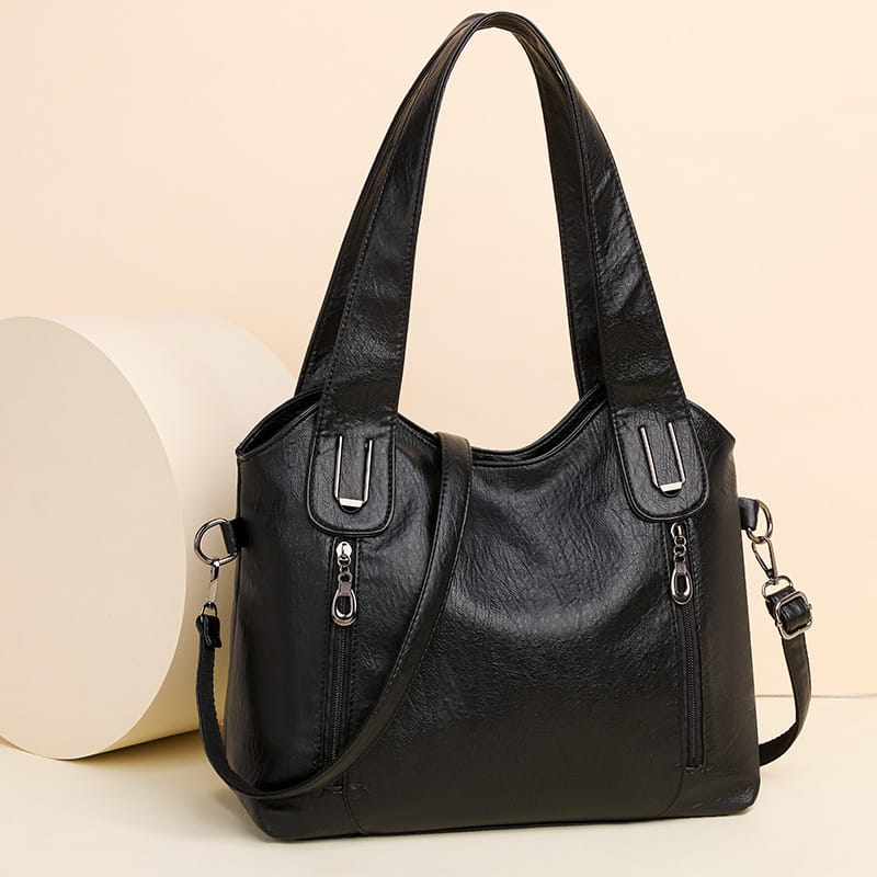 Black leather large capacity handbag with double handles and stylish zipper details.