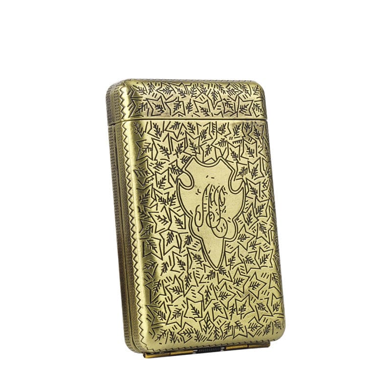 Ornate gold-colored metal case with intricate leaf patterns and monogram engraving.