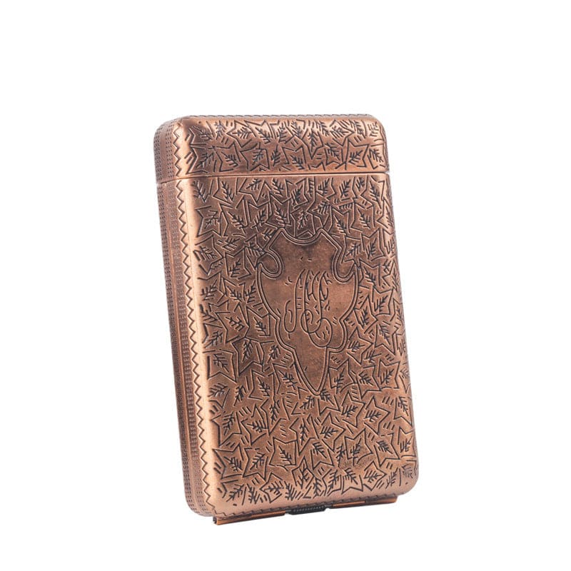 Ornate copper-colored cigarette case with intricate engraved patterns.