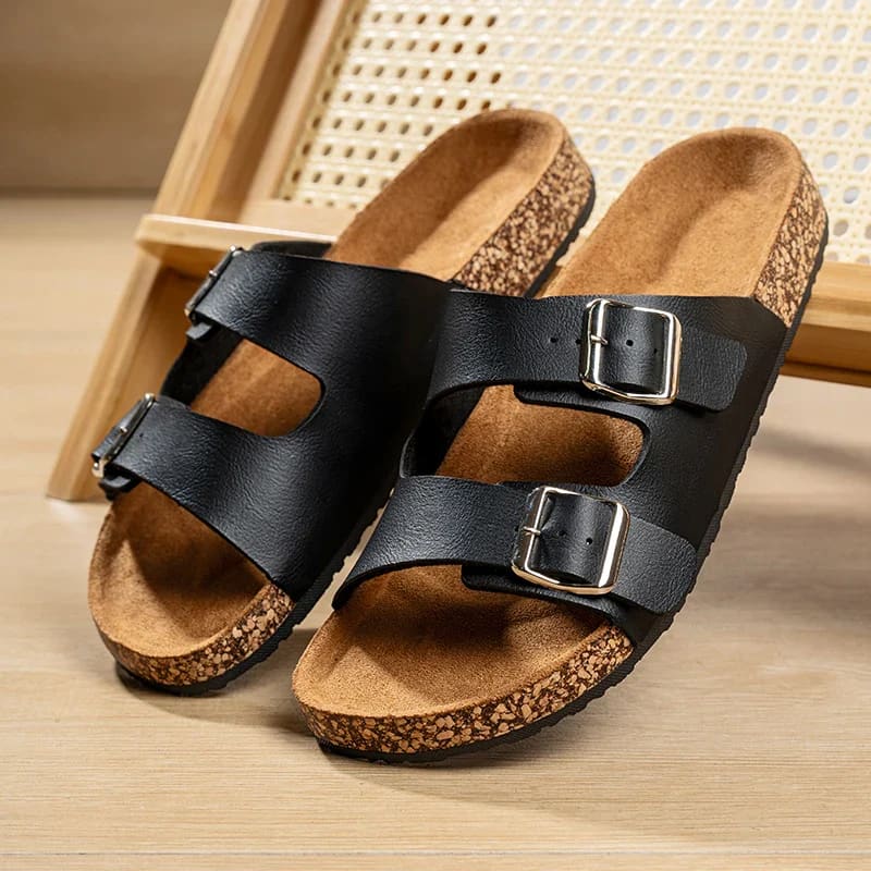 Black leather sandals with cork footbeds and buckle straps, perfect summer cork shoes for men.