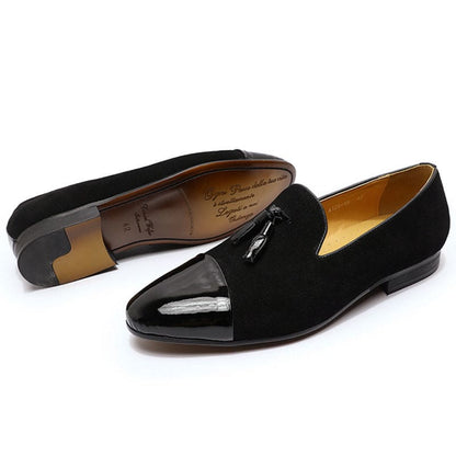 Pair of black suede loafers with patent leather toe caps.