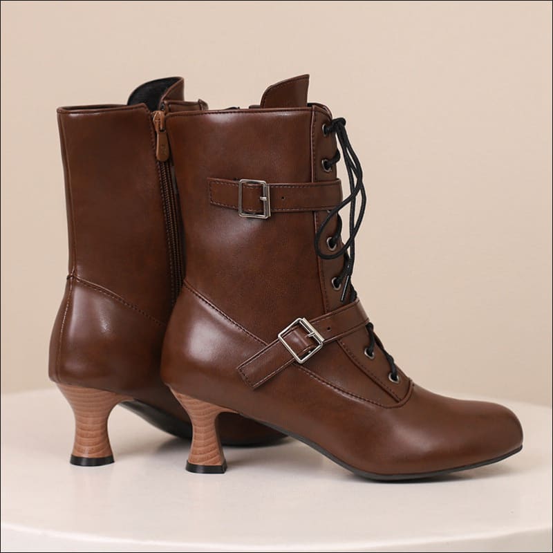 Brown leather mid heel lace-up boots with buckle straps for stylish Steampunk vibes.