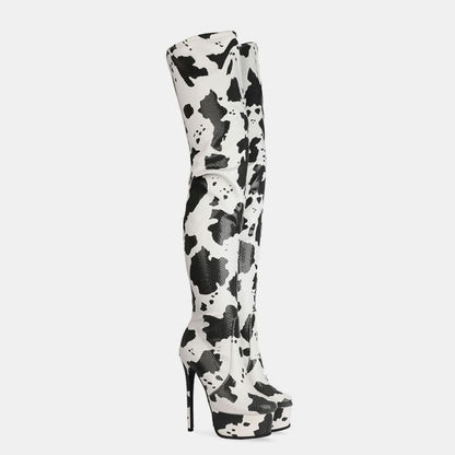 Thigh-high boot with a cow print pattern and very high stiletto heel.