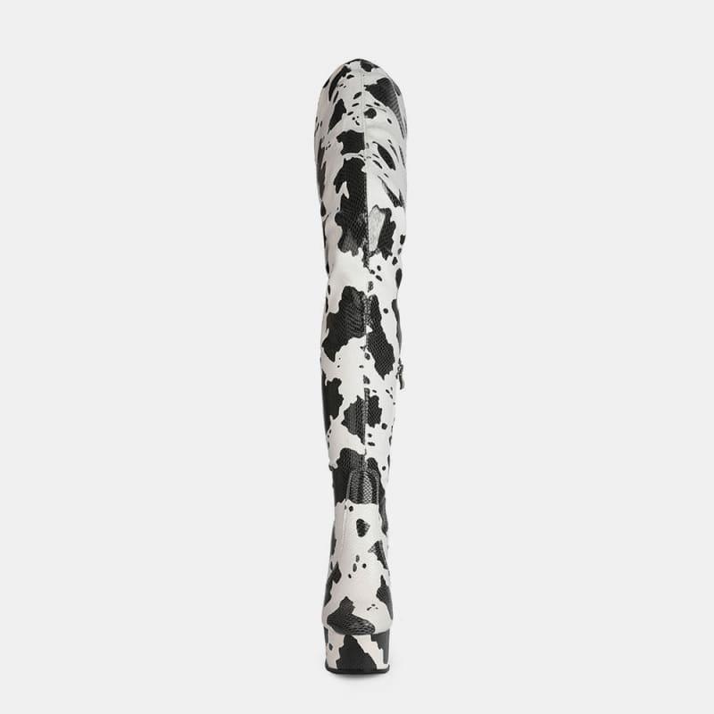 Tall, cylindrical object with a black and white spotted or splattered pattern.