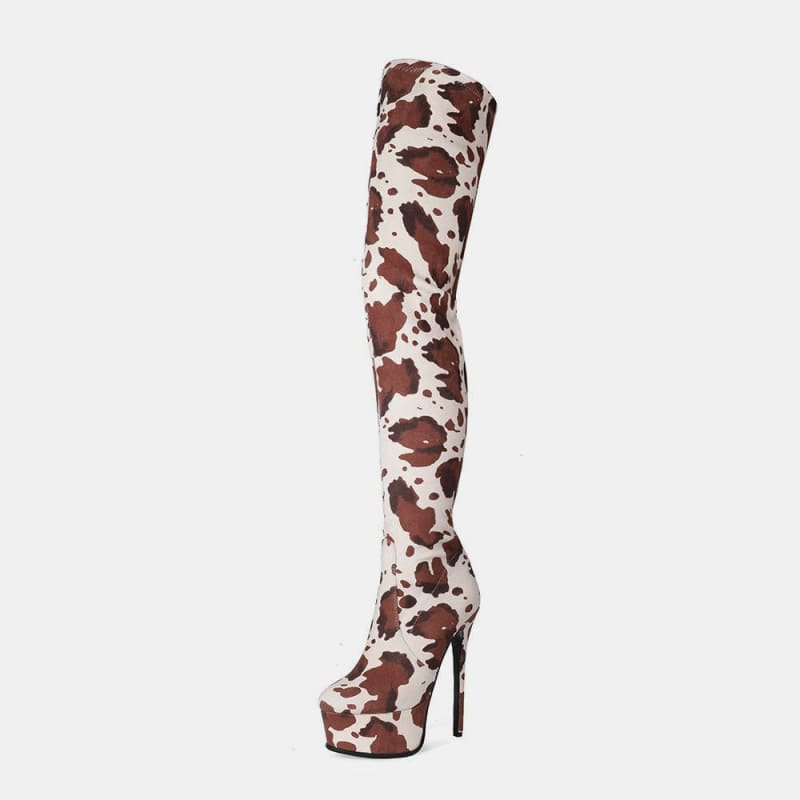 Thigh-high boot with a cow print pattern and very high stiletto heel.