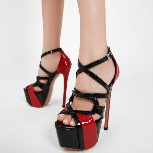 Pair of red and black high-heeled platform sandals with strappy design.