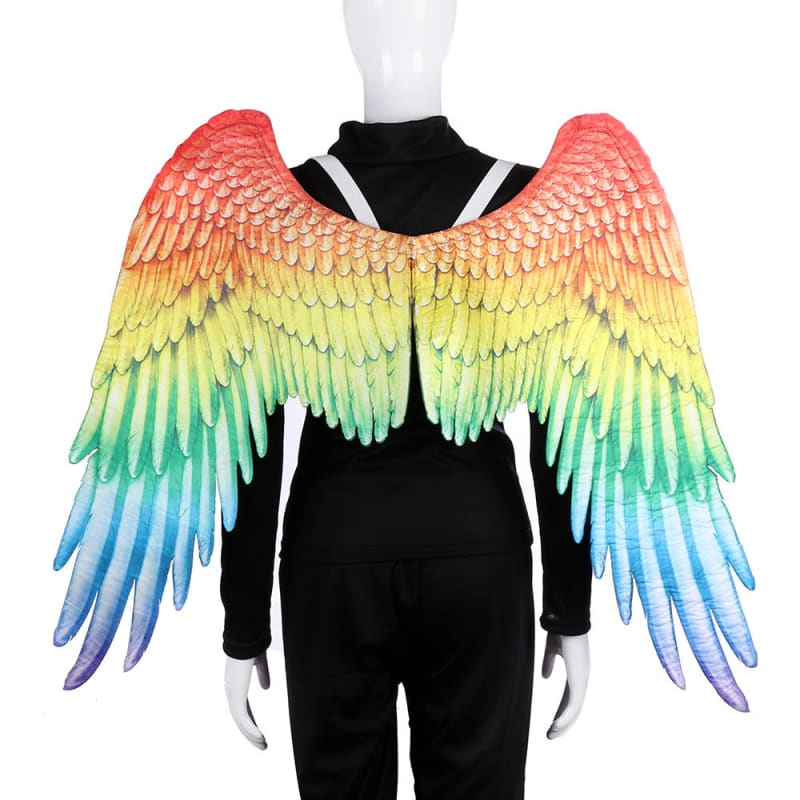 Colorful rainbow-patterned wings attached to a black-clothed mannequin torso.