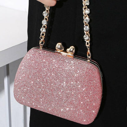 Glittery pink clutch purse with a gold chain strap and clasp.