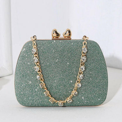 Glittery mint green clutch purse with a gold chain strap.