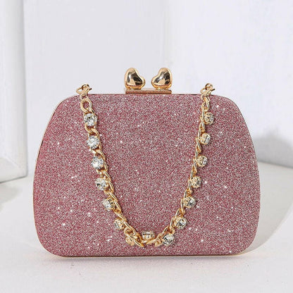 Glittery pink evening clutch purse with a gold chain strap and clasp.