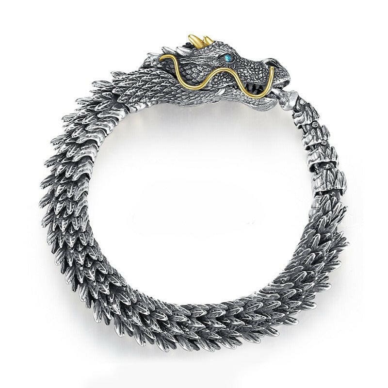 Ornate silver dragon bracelet with a gold-accented head.