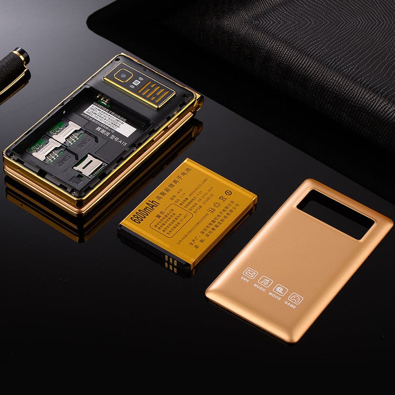 Gold-colored flip phone with its battery and back cover removed, displaying internal components.