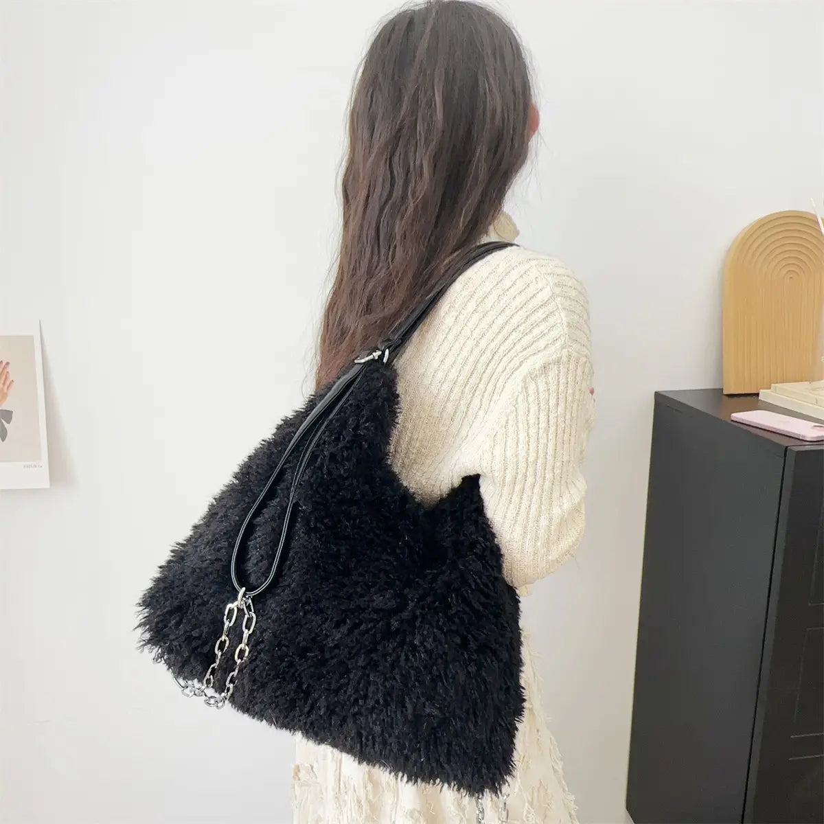 Fluffy black faux fur handbag with chain strap, perfect plush large capacity style.