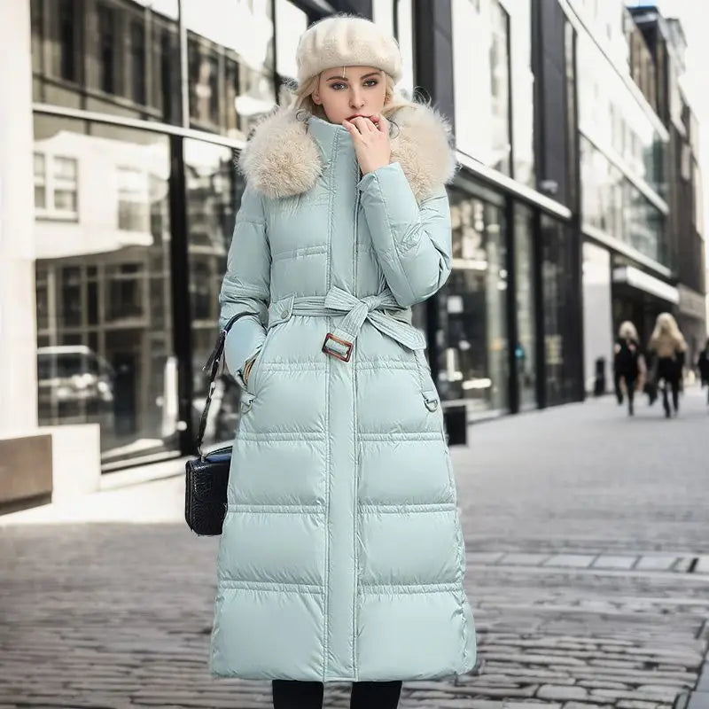 Light blue ladies long padded coat with luxurious fur-trimmed hood and belt.