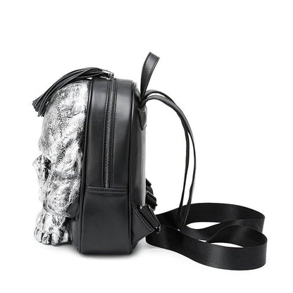 Backpack with a furry or textured silver panel on one side and black leather on the other.