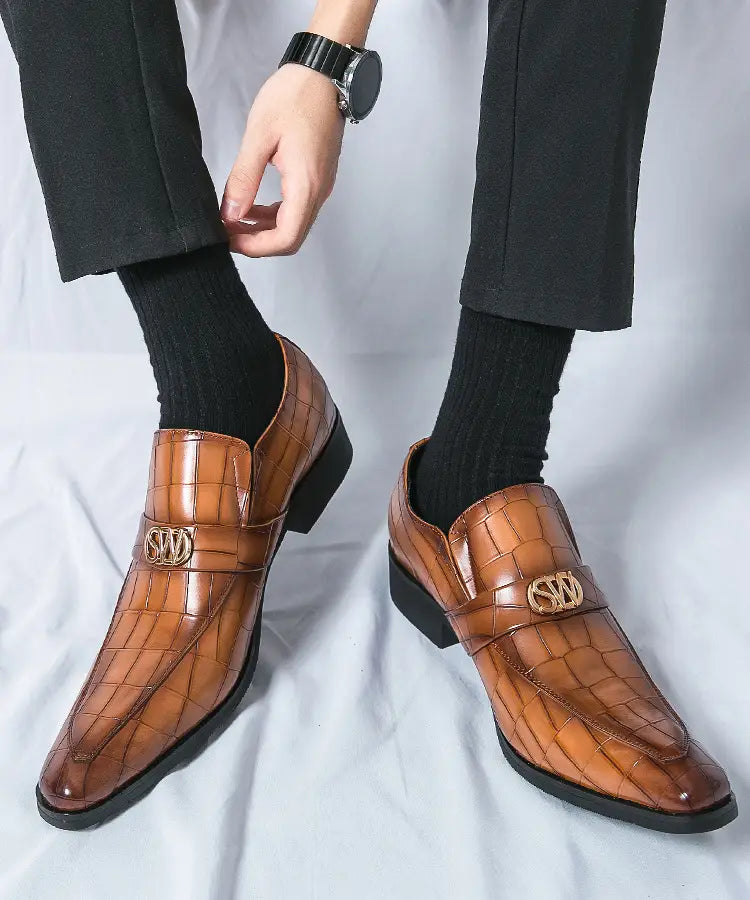 Brown leather loafers with decorative buckles in crocodile pattern casual style.