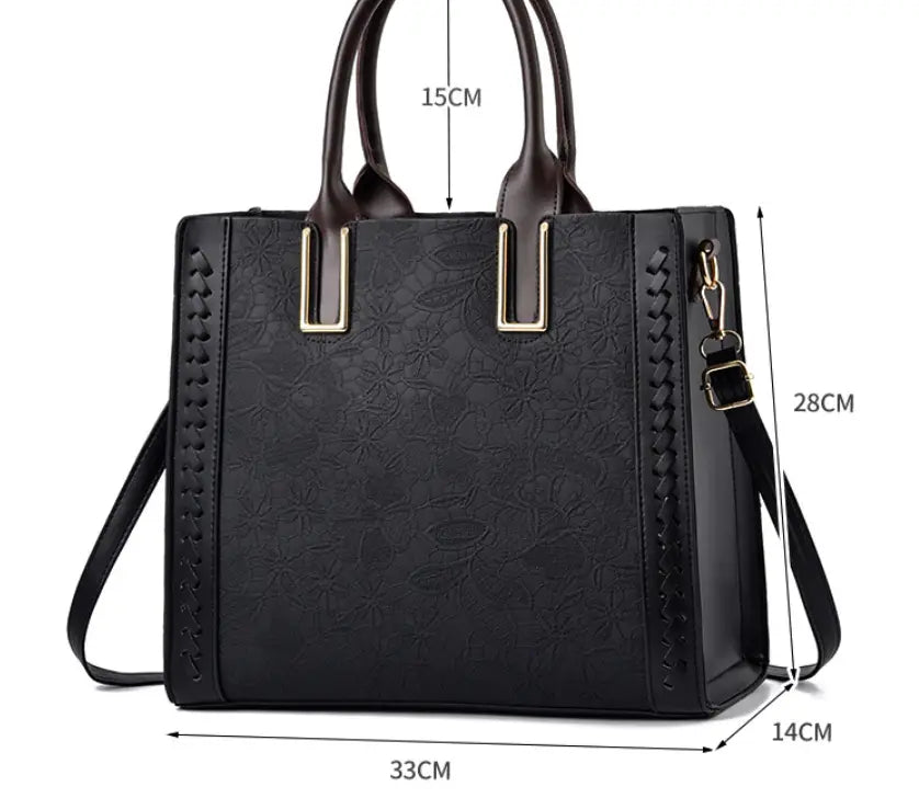 Black structured handbag with braided trim, metal accents for elegant shoulder style.