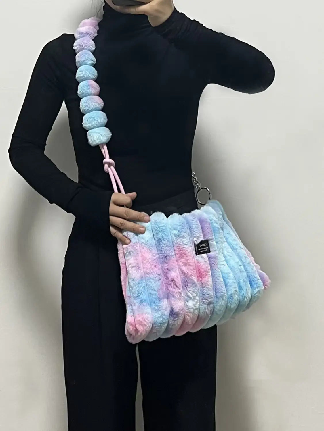 Pastel tie-dye plush retro crossbody bag with soft fur exterior in pink, blue, and purple.