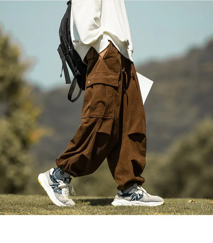 Brown Corduroy cargo pants with pockets, matched with cool gray sneakers for a casual vibe.