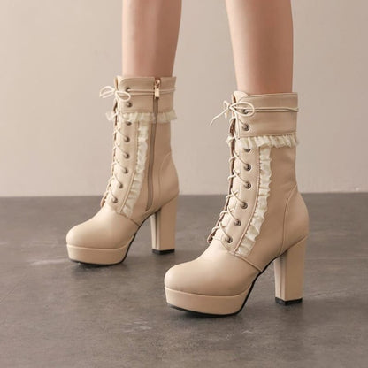 Pair of cream-colored lace-up platform boots with high chunky heels.