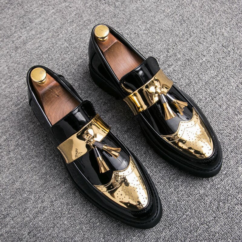 Pair of black and gold loafers with tassels and metallic toe caps.