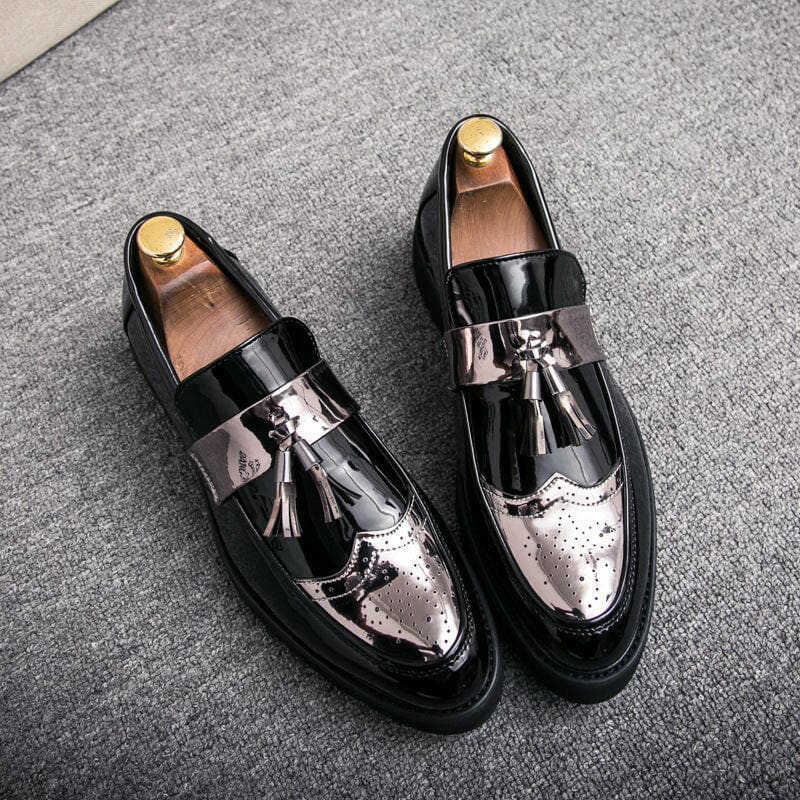 Pair of stylish two-tone leather loafers with tassels and brogue detailing.