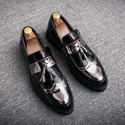 Pair of black leather loafers with silver metallic accents and tassels.