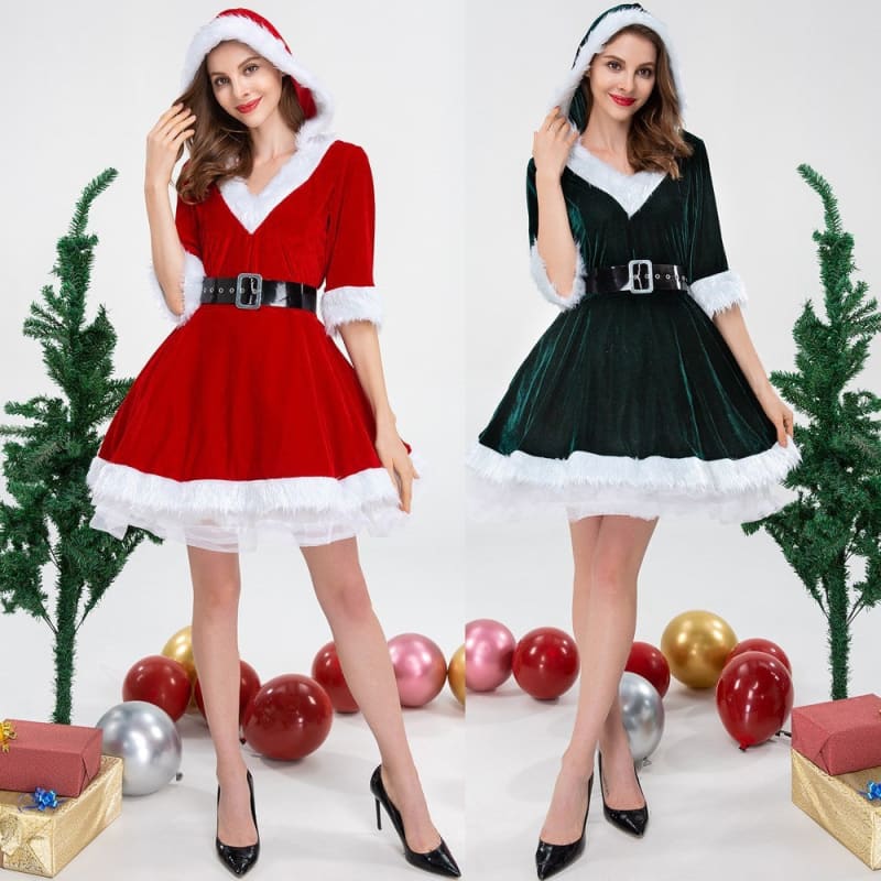 Two women wearing festive Christmas-themed dresses, one in red and one in green.