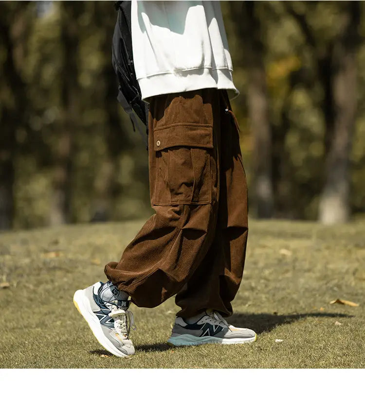 Men’s Stylish Wide-leg Corduroy Cargo Pants in brown, paired with gray sneakers.