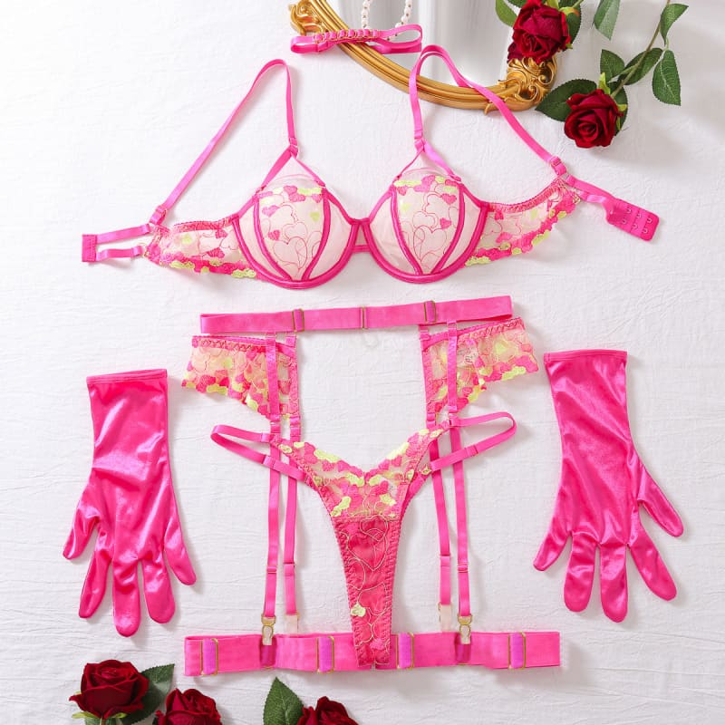 Hot pink lingerie set with bra, garter belt, thong, and gloves featuring floral lace details.