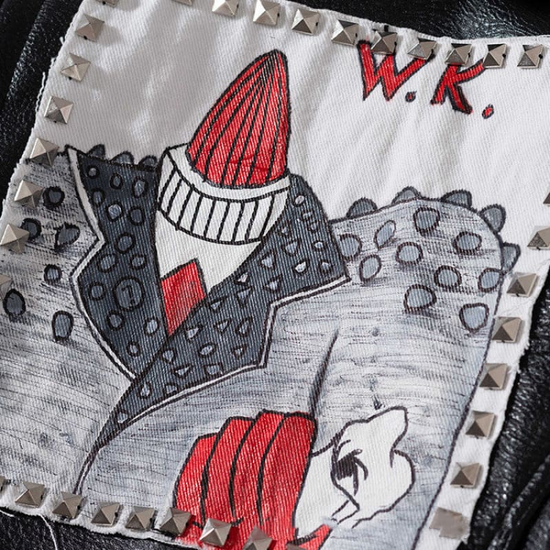 Hand-drawn illustration of a stylized figure wearing a polka dot suit and red hat on a fabric patch.