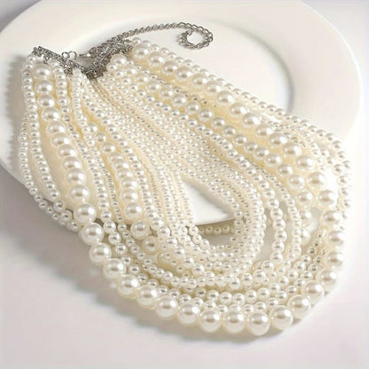 Multi-strand pearl necklace with varying bead sizes.