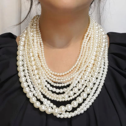 Multi-strand pearl necklace with varying bead sizes.