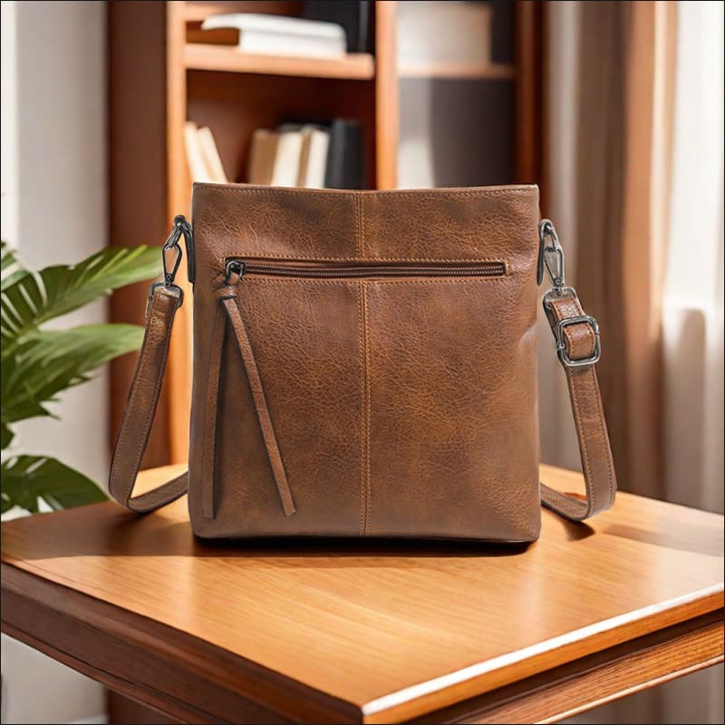 Brown leather crossbody bag with zipper pocket, a stylish high-end textured artificial leather design.