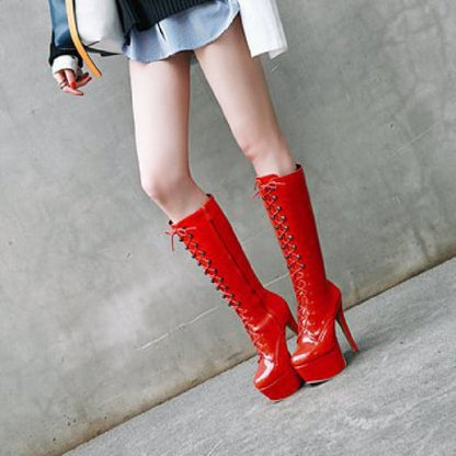 Bright red knee-high platform boots with laces up the front.