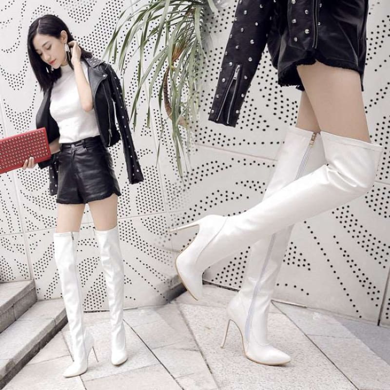 White knee-high boots with very high stiletto heels.