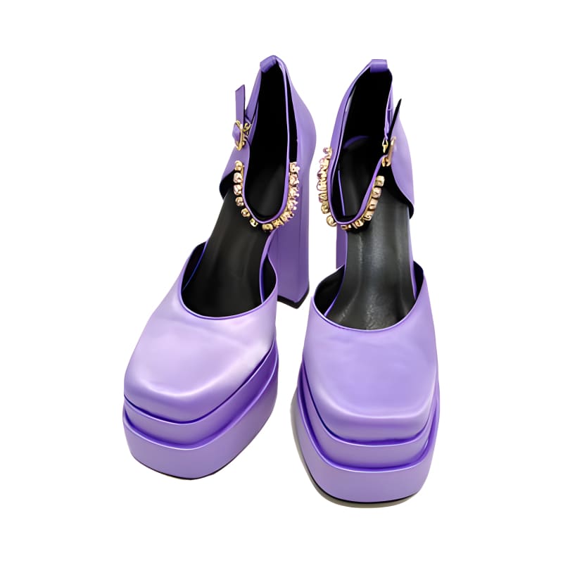 Pair of lavender platform shoes with chunky soles and jeweled ankle straps.