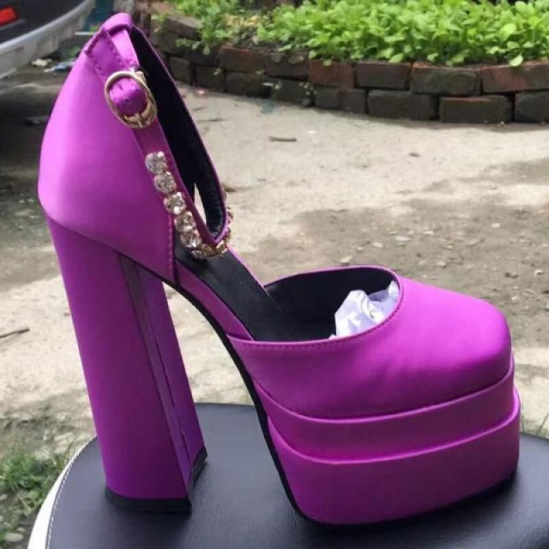 Bright purple platform high heel shoe with a chunky heel and closed toe.