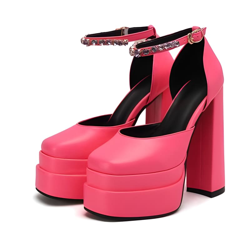 Bright pink platform high heels with ankle straps and chunky soles.