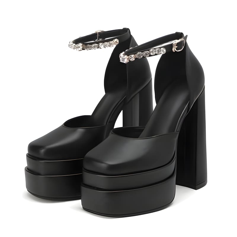 Black platform high heels with chunky soles and rhinestone ankle straps.